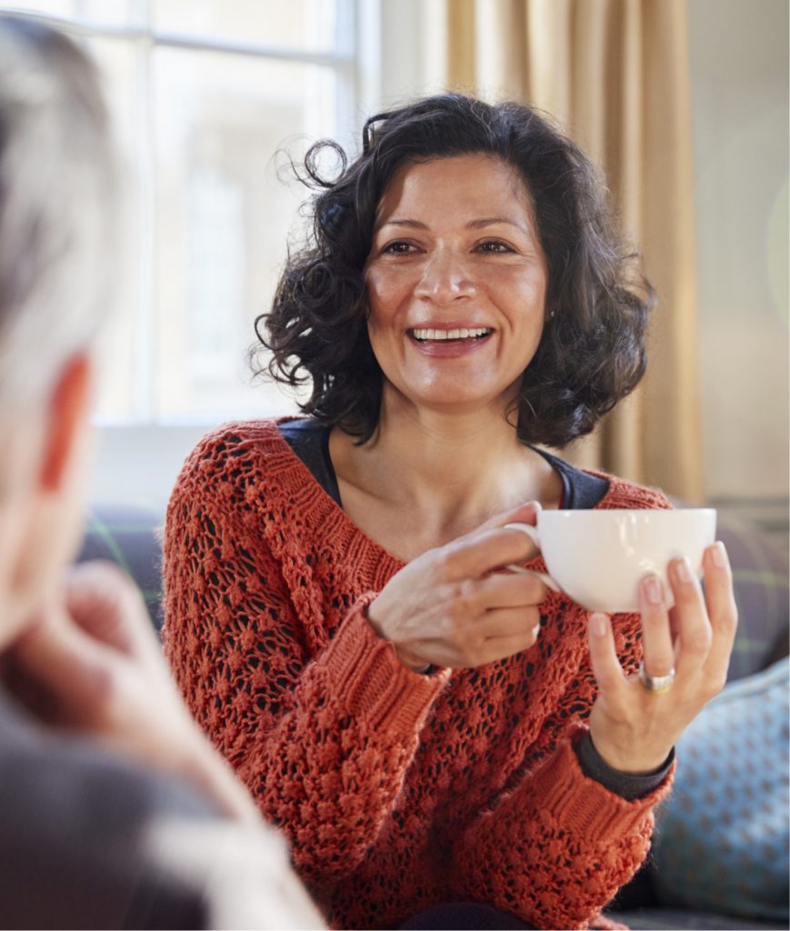 Woman drinking tea to control her high blood pressure